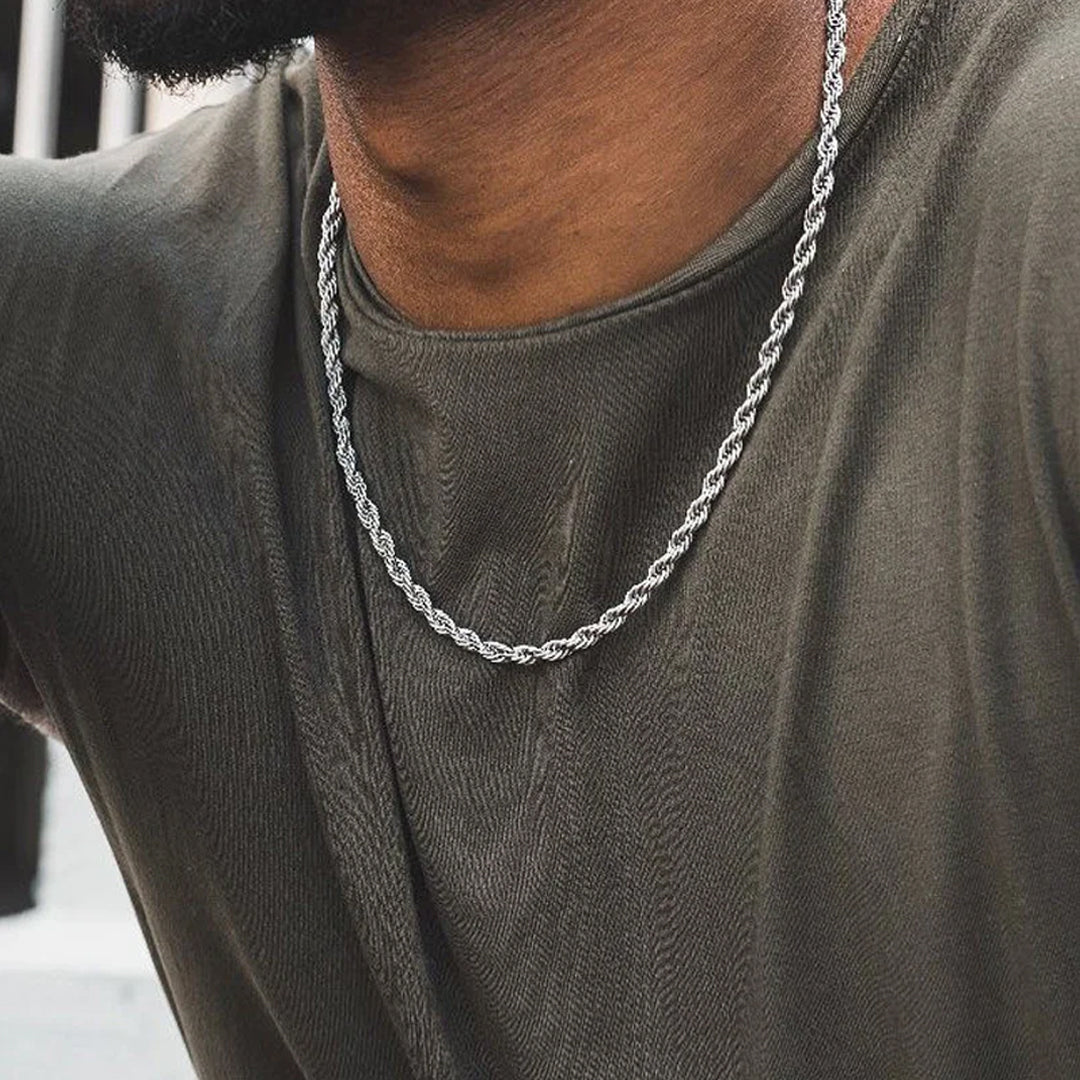 Close-up of a stainless steel twisted Cuban chain necklace with a polished, reflective finish, showcasing its intricate interlocking links and stylish, modern design.