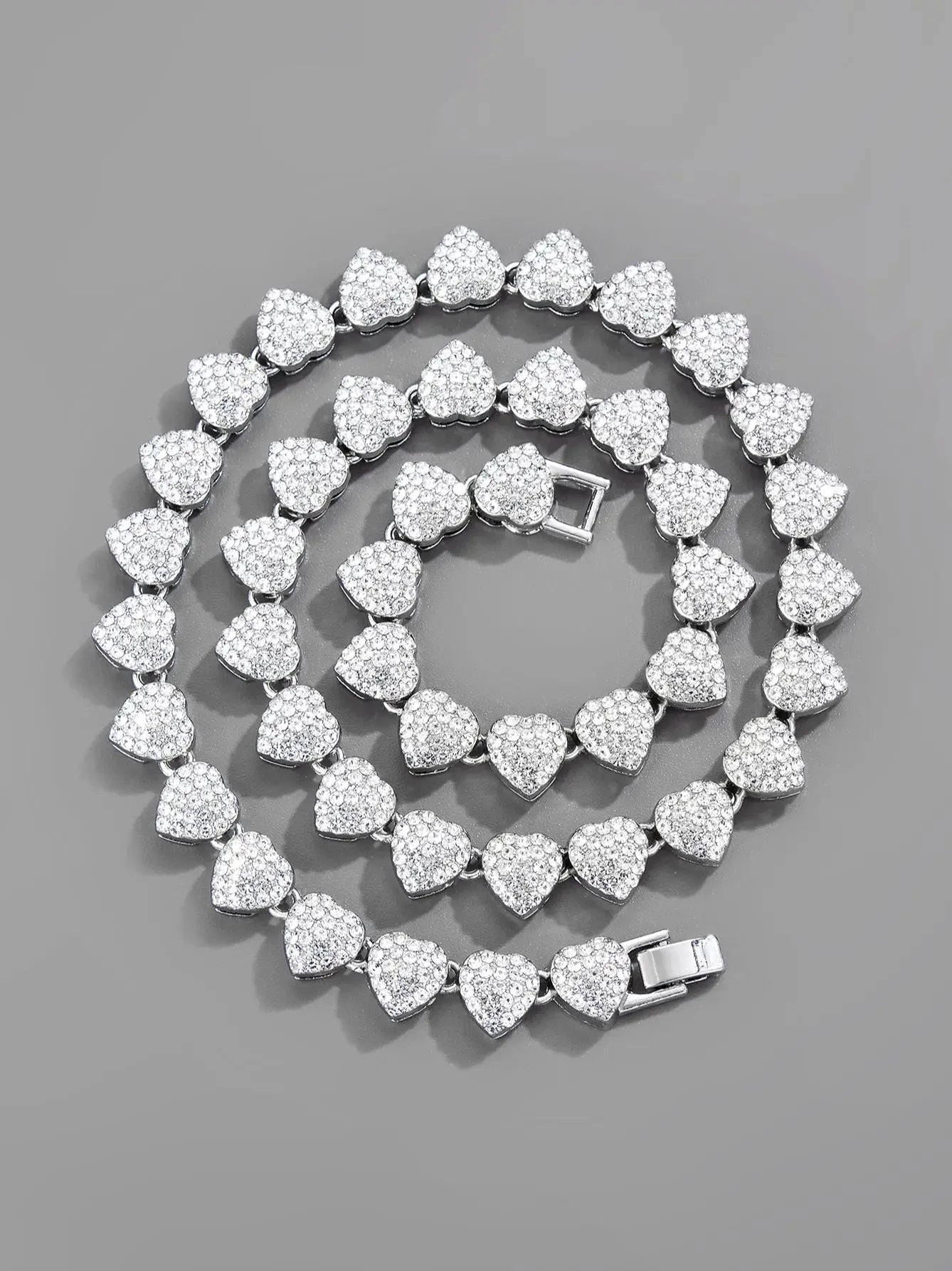 Iced out Cuban link chain featuring heart shaped charm